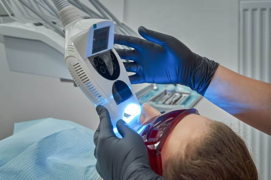 Woman undergoing procedure of teeth whitening